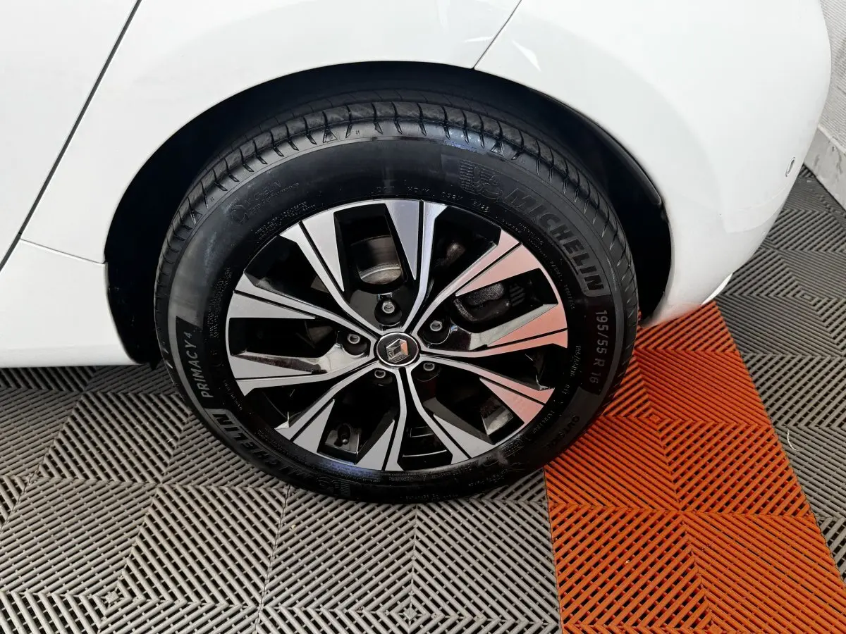 Gros plan sur la roue arrière droite blanche d'une Renault ZOE Iconic R135 avec jante alliage bicolore et pneu Michelin.