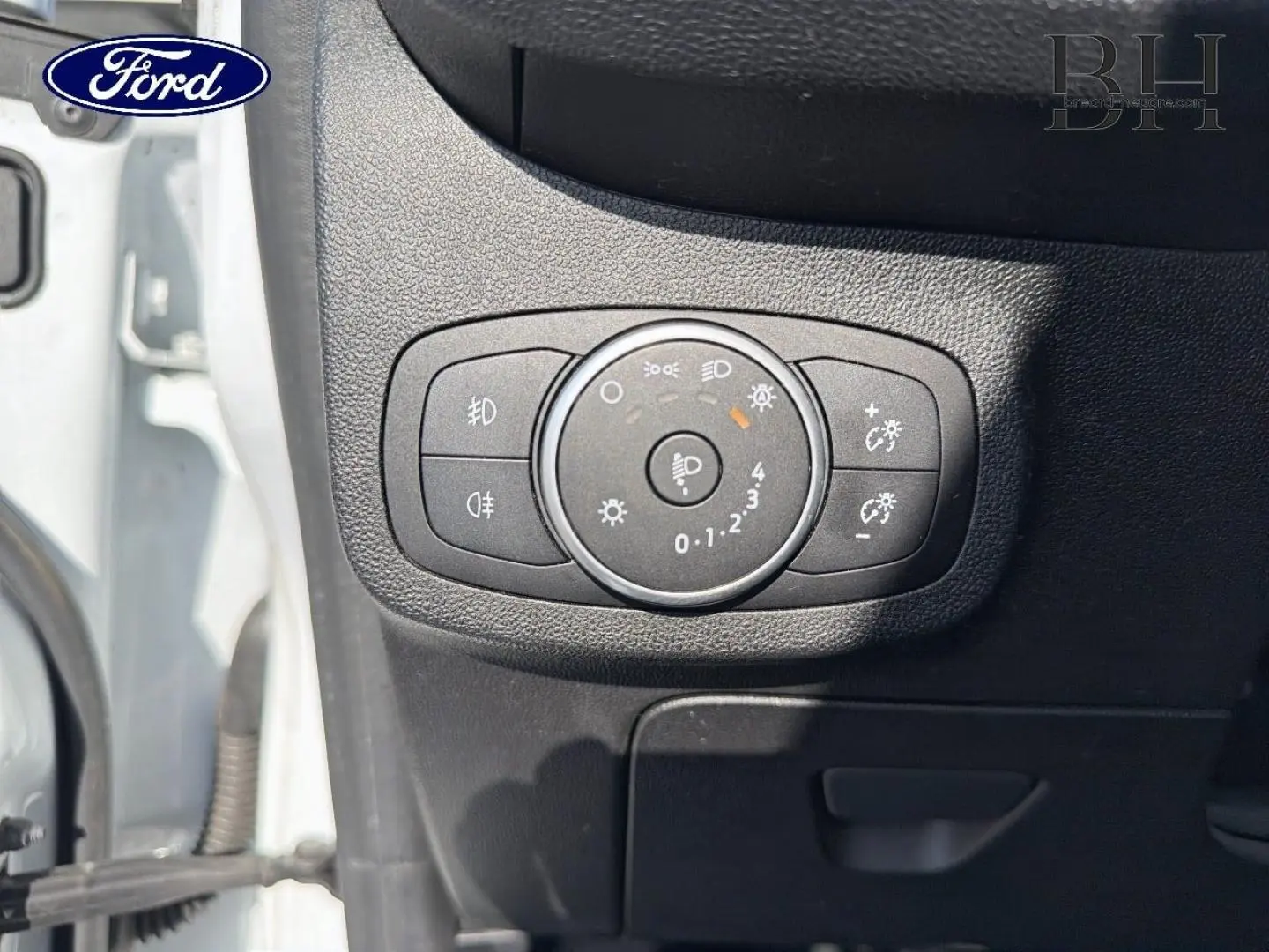 Détail du tableau de bord côté gauche avec commande d'éclairage sur Ford Fiesta blanc glacier 2018.