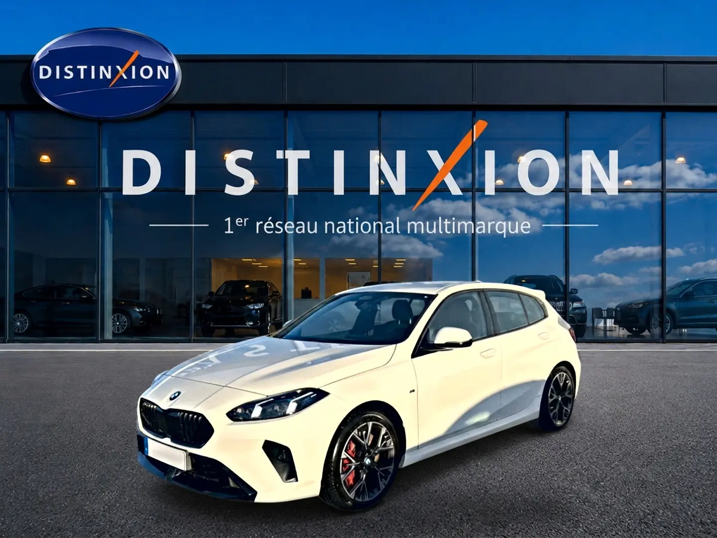 BMW Série 1 blanc alpin vue 3/4 avant droit, jantes 18 pouces bicolores et calandre noire M Sport.