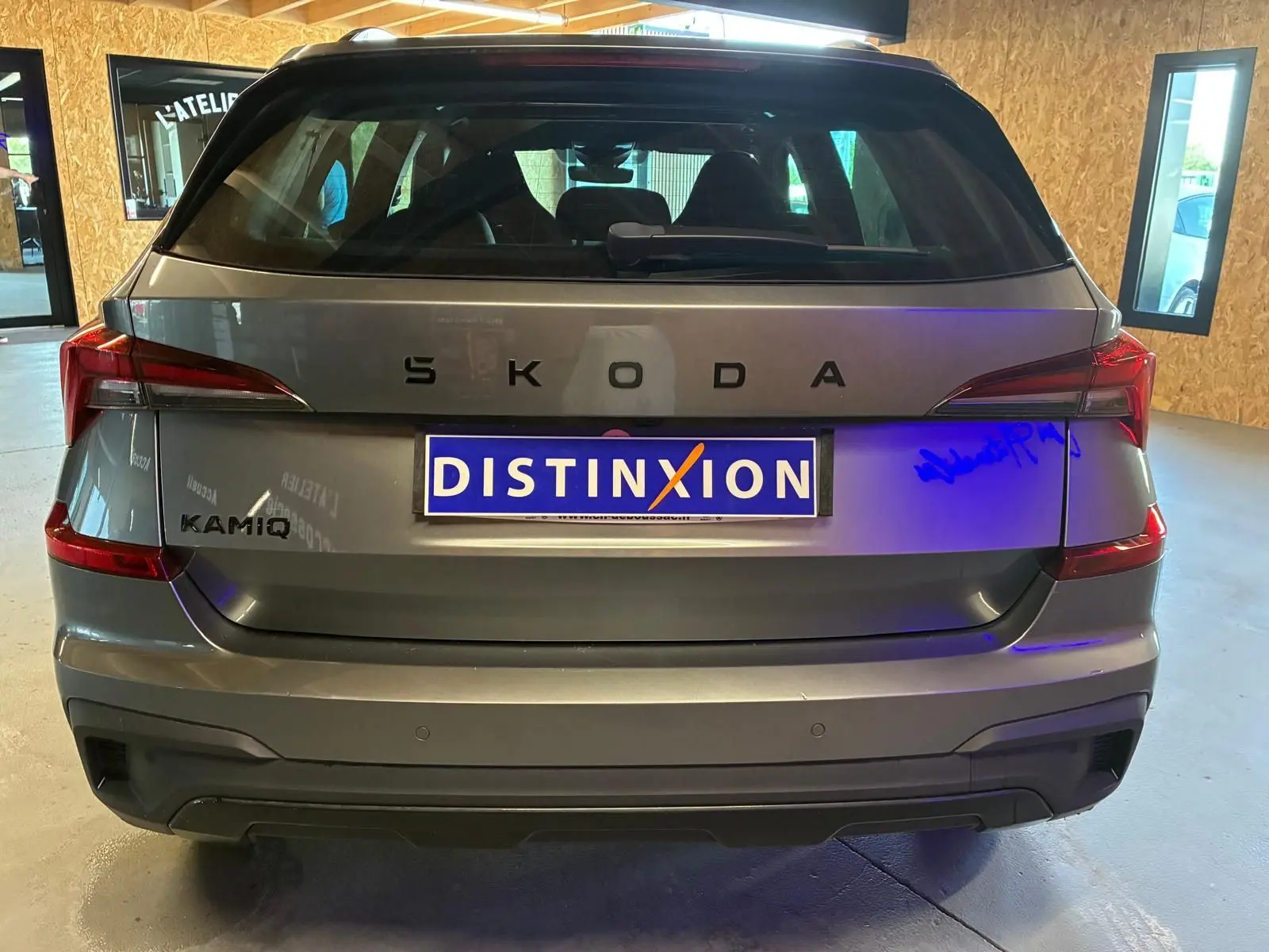 Vue arrière d'un Skoda Kamiq gris foncé 2024 avec feux arrière LED et logo SKODA en lettres espacées.