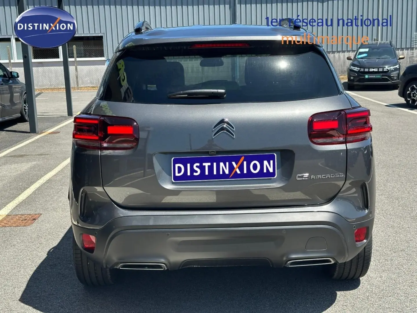 Vue arrière d'un Citroën C5 Aircross gris Platinium avec feux arrière LED et double sortie d'échappement intégrée.
