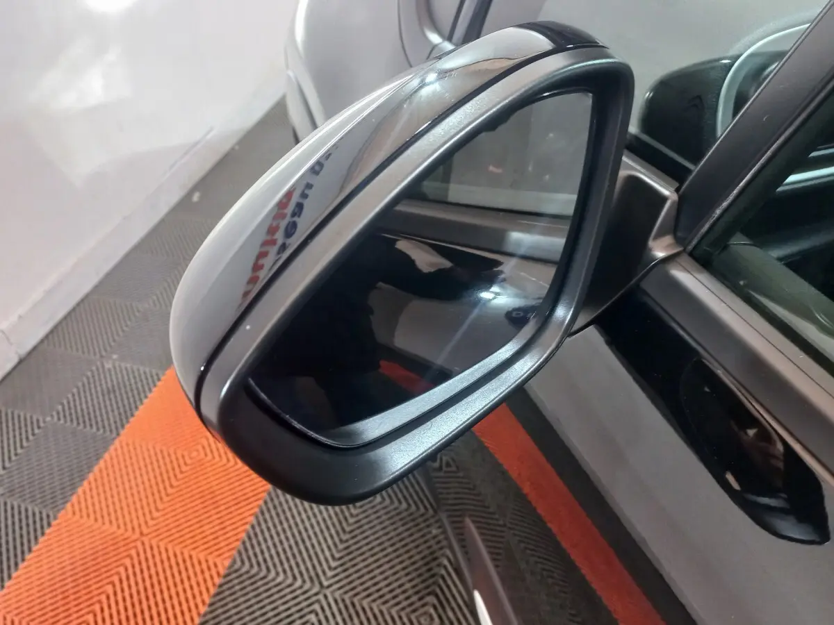 Rétroviseur extérieur droit noir de Citroën C3 2024, vue rapprochée avec reflet sur surface brillante.
