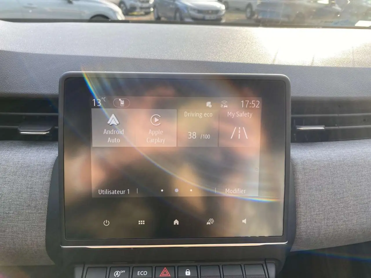 Écran tactile central de la Renault Clio 2025 affichant Apple CarPlay, avec tableau de bord gris en arrière-plan.