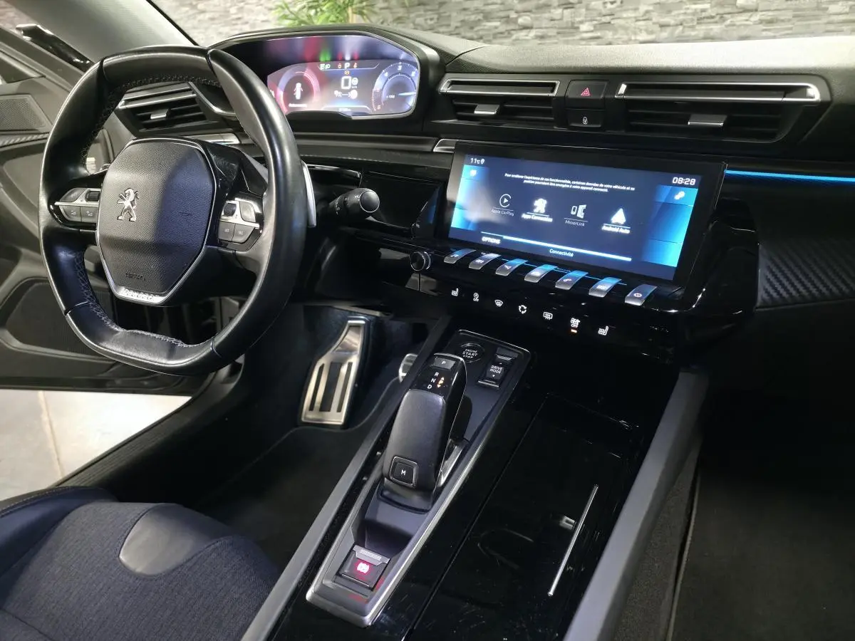Intérieur noir de la Peugeot 508 SW 2019, vue côté conducteur sur le volant compact et l’écran tactile central.