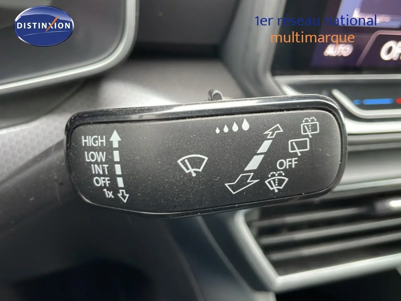 Gros plan sur la commande d’essuie-glace du SEAT LEON 2.0 TDI 115CH STYLE XL avec tableau de bord gris en arrière-plan.