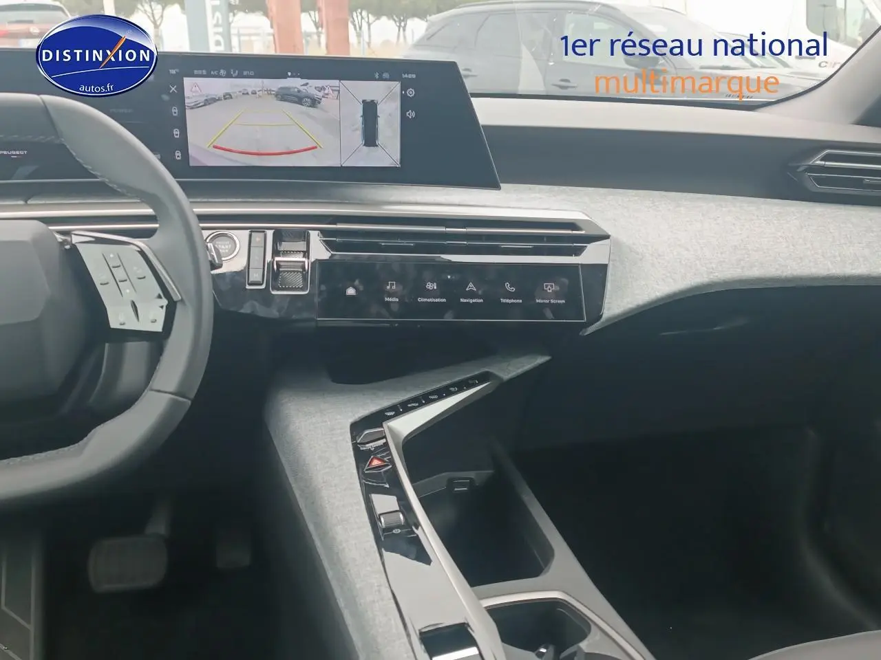 Vue intérieure du tableau de bord du Peugeot 5008 Hybrid gris, avec écran tactile et volant multifonction visible côté gauche.