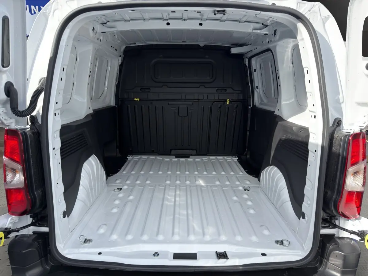 Vue arrière ouverte du Citroën Berlingo blanc 2026 montrant l'espace de chargement vide et la cloison pleine noire.