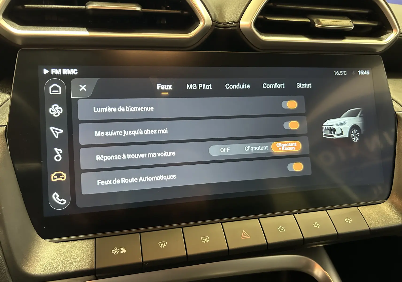 Écran tactile central du MG ZS 1.5 Hybrid+ 197 Luxury en vue rapprochée, affichant les réglages des feux avec illustration du véhicule blanc.