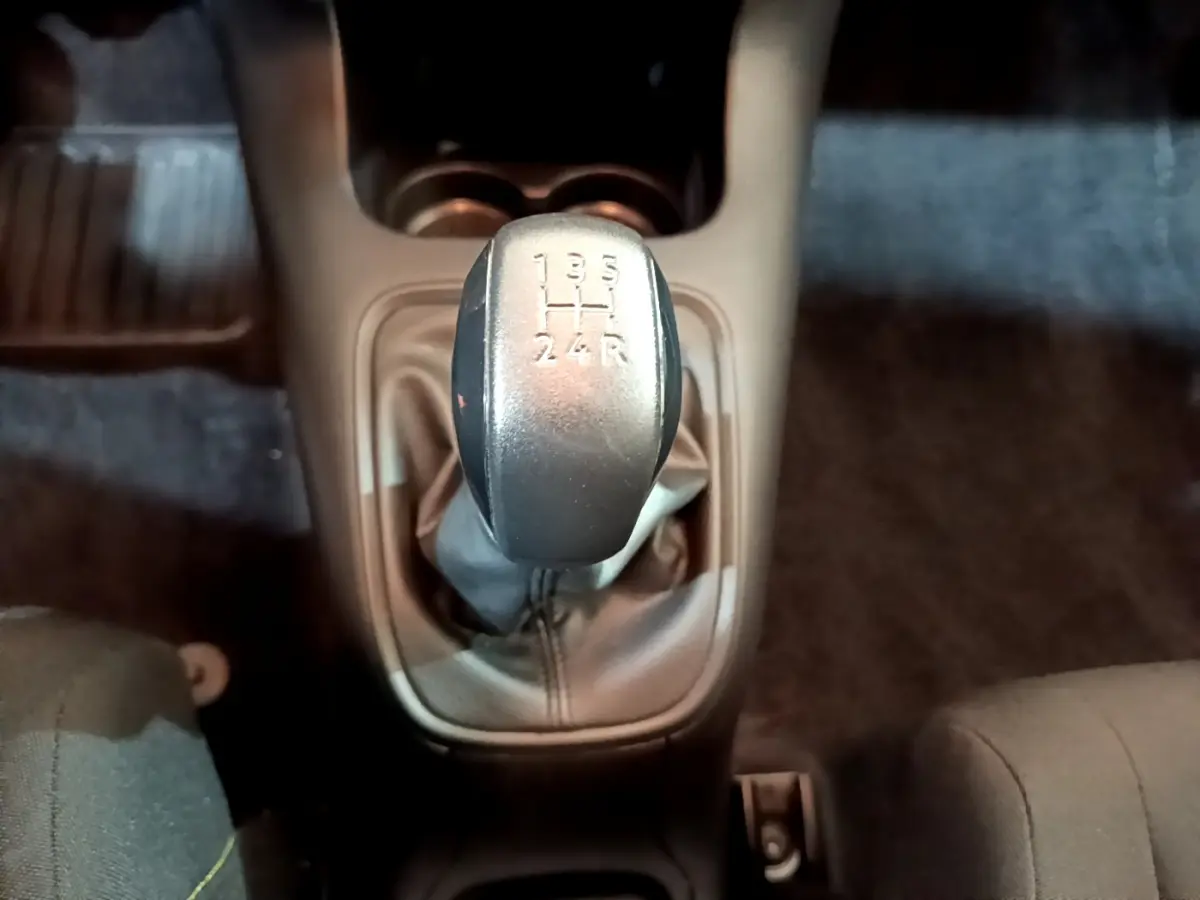 Gros plan sur le levier de vitesse manuel gris de la Citroën C3 PureTech 68 BVM Feel 2018, intérieur sombre.