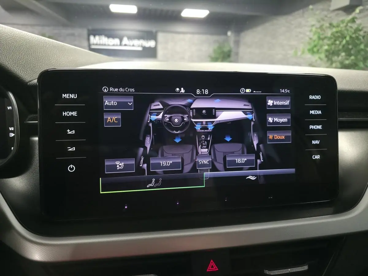 Écran tactile central affichant le contrôle de la climatisation du Skoda Kamiq gris, vue intérieure frontale.
