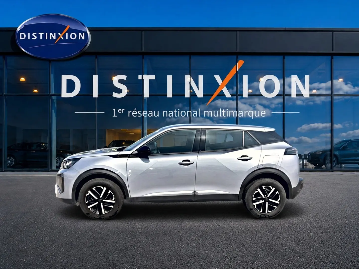 Peugeot 2008 gris en profil droit, avec toit noir contrasté et jantes noires à motifs argentés.