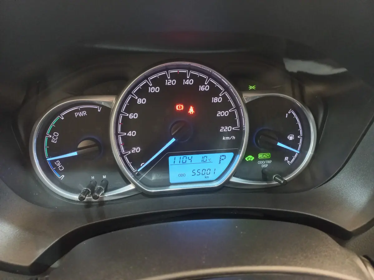 Gros plan sur le tableau de bord de la Toyota Yaris hybride 2018, affichant la vitesse, jauges énergie et carburant, et écran digital bleu.