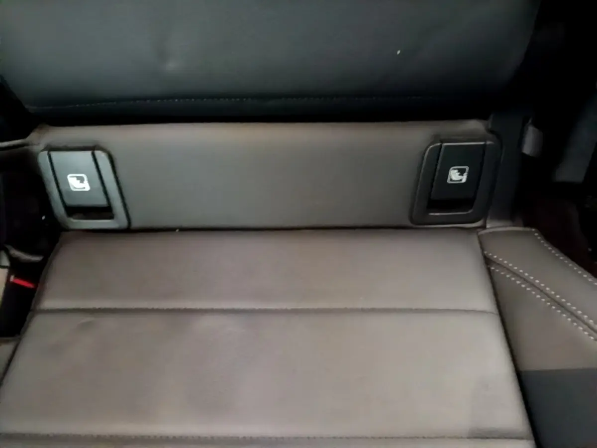 Détail des commandes de rabattement des sièges arrière en cuir noir du BMW X1 xDrive23i M Sport 2023.