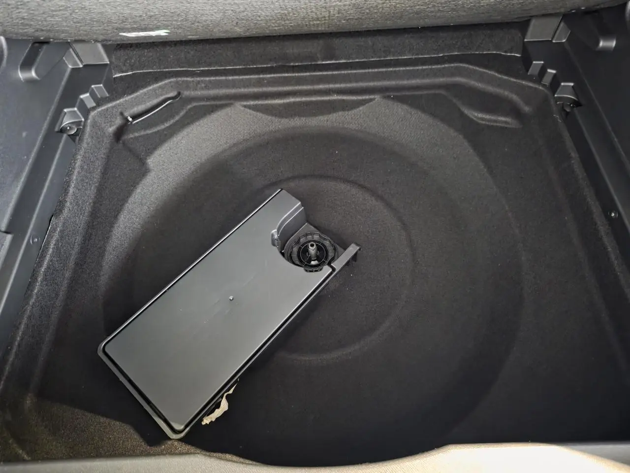 Vue rapprochée du coffre du Citroën C5 Aircross noir métal, montrant le rangement sous plancher vide.