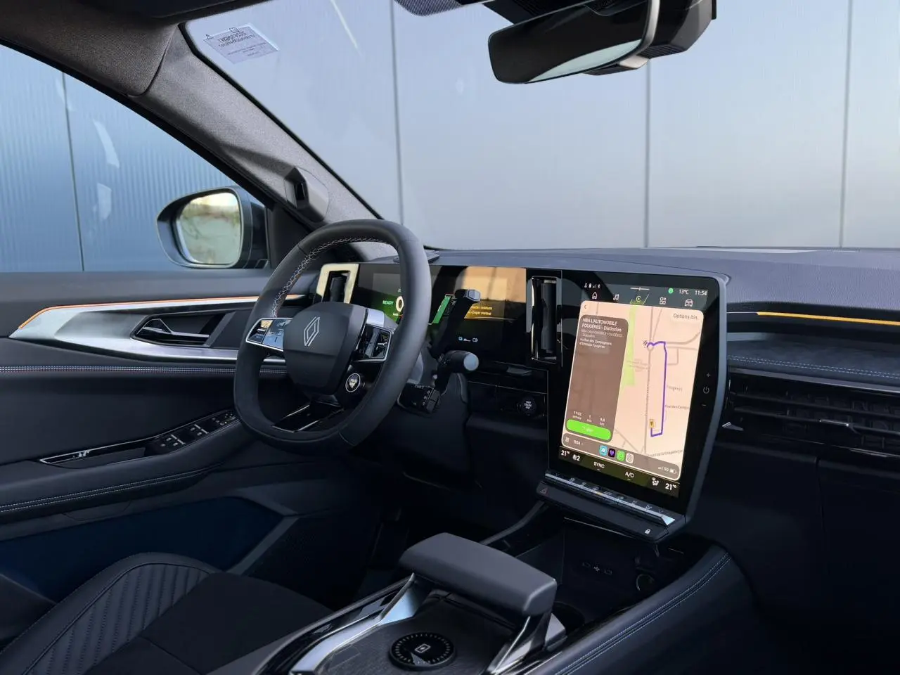 Vue intérieure côté conducteur du Renault Rafale E-Tech 2026 avec écran tactile vertical et volant à insert Alcantara.