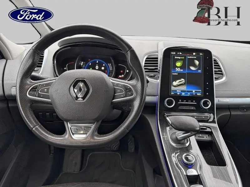 Vue intérieure centrée sur le volant cuir et la console centrale avec écran tactile du Renault Espace blanc Glacier de 2015.