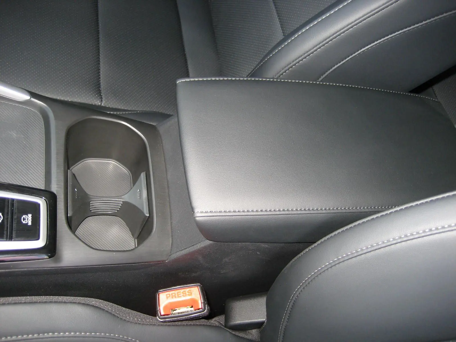 Gros plan sur la console centrale et accoudoir en cuir noir du MG ZS 1.5 HYBRID+197 LUXURY 2026.