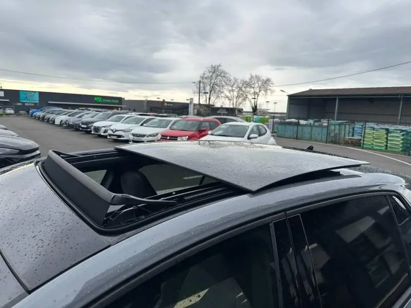 Toit ouvrant panoramique ouvert sur une Volkswagen Golf gris Urano vue de dessus côté gauche.