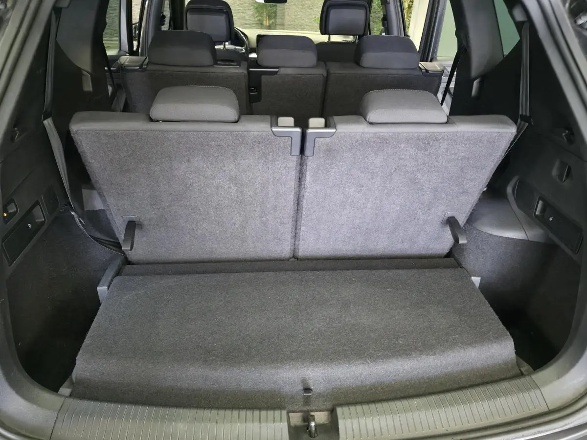 Vue depuis l'arrière du coffre du SEAT Tarraco gris, montrant la banquette arrière relevée et les appuie-tête noirs.