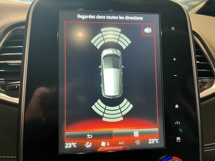 Écran tactile intérieur du Renault Scenic IV montrant l'alerte de détection d'obstacles en vue aérienne.