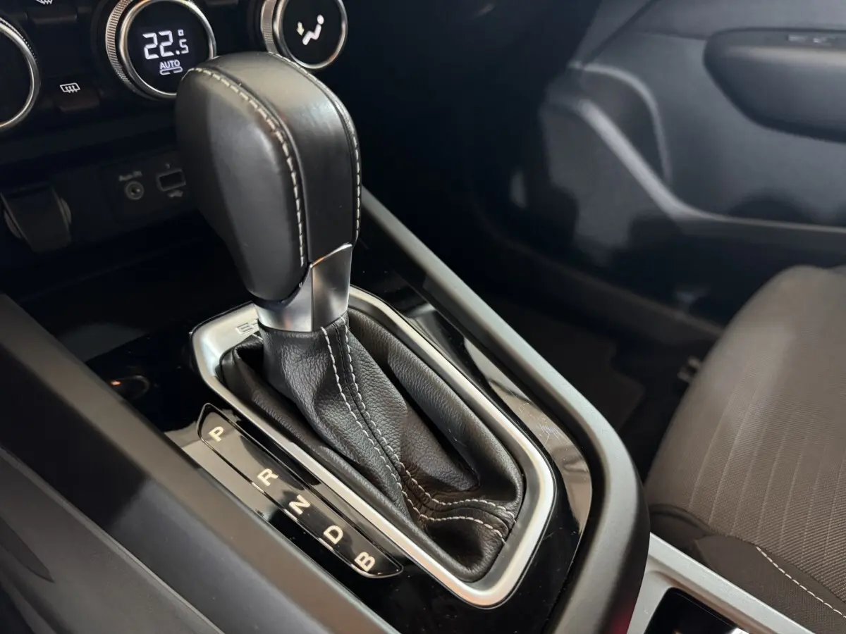 Gros plan sur le levier de vitesses automatique noir et gris dans l’habitacle du Renault Arkana Business E-TECH 145.