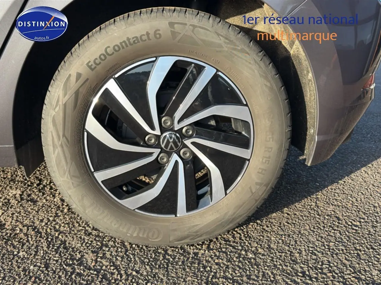 Gros plan sur la roue avant droite d'une Volkswagen Polo gris métallisé avec jante alu bicolore.