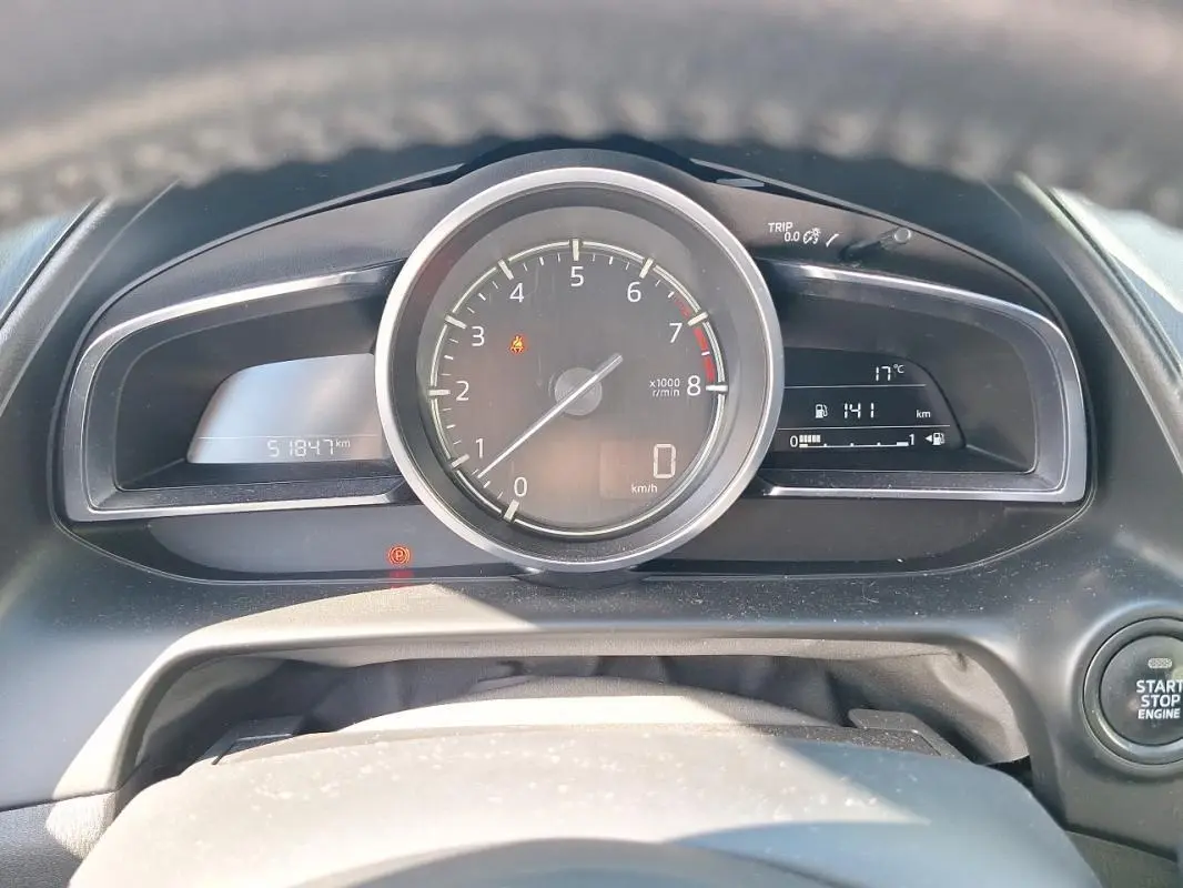 Vue rapprochée du tableau de bord du Mazda CX-3 2021, affichant le compte-tours central et les écrans numériques.
