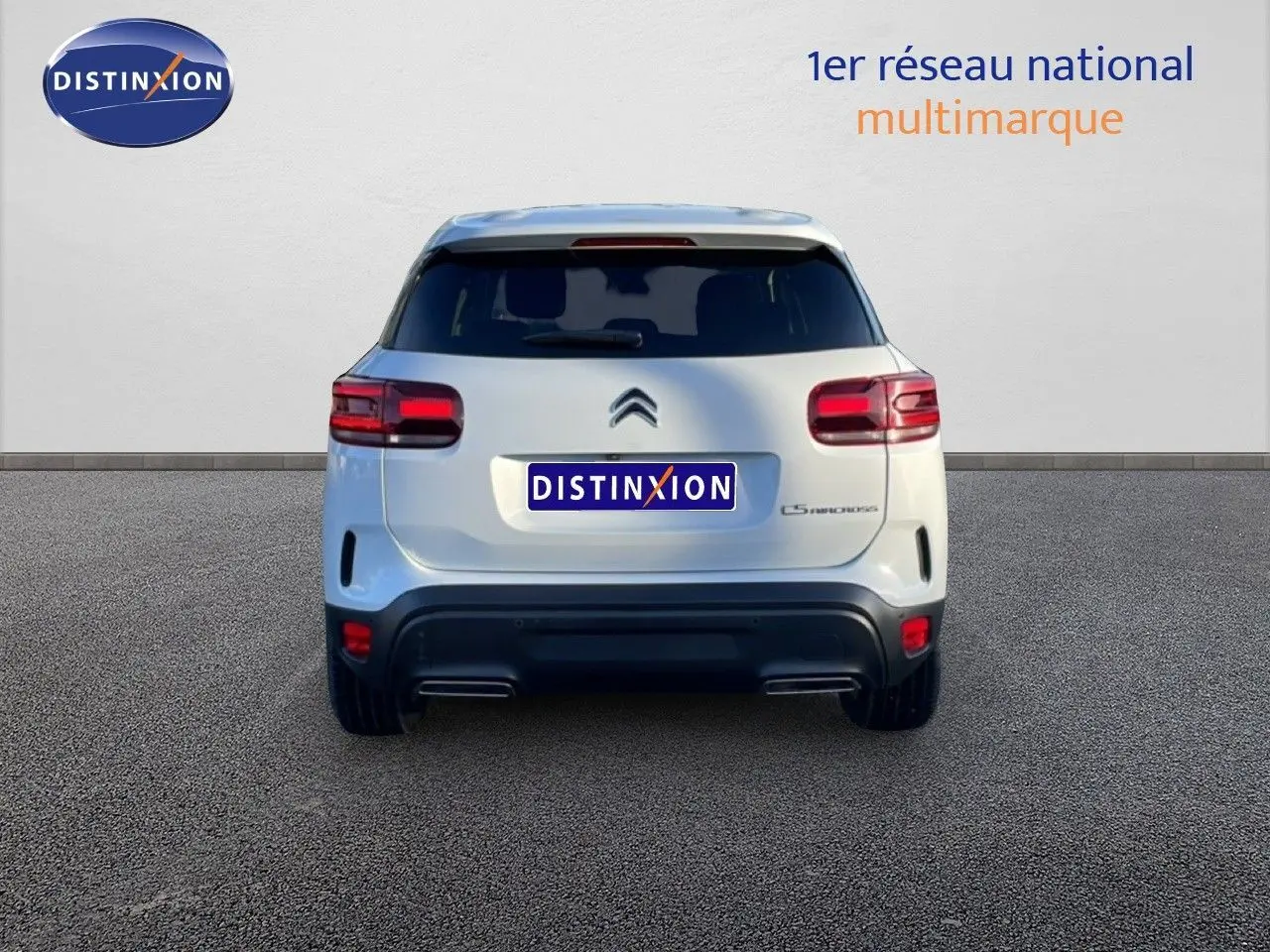 Vue arrière d'un Citroën C5 Aircross blanc Okenite Metal avec feux rouges et double sortie d'échappement.