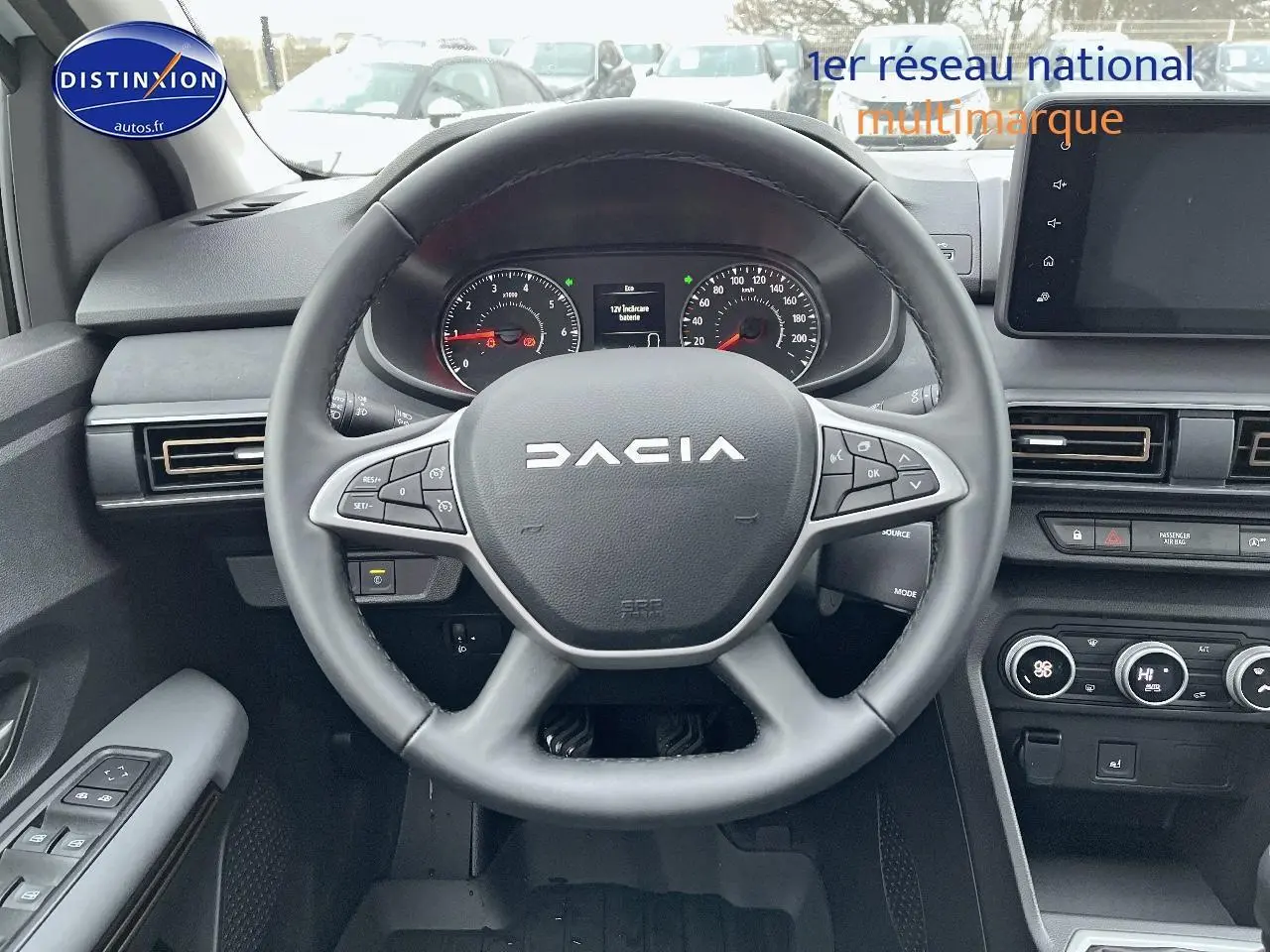 Vue intérieure centrée sur le volant noir du Dacia Jogger 2025 avec tableau de bord et écran tactile visible.