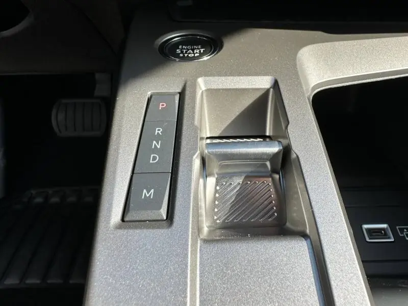 Gros plan sur la console centrale gris Artense de la Peugeot 308 2025 avec bouton start/stop et commandes boîte auto.