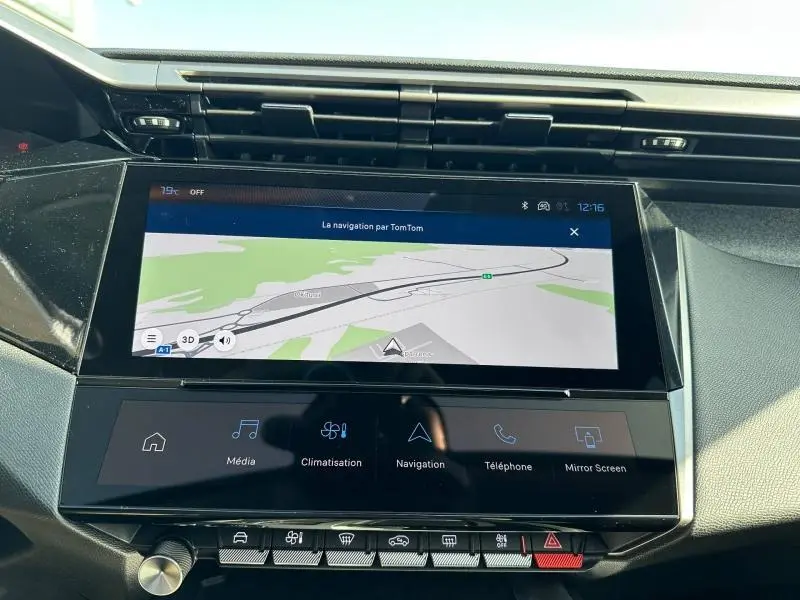 Vue rapprochée de l’écran tactile central du tableau de bord de la Peugeot 308 gris Artense, affichant la navigation TomTom.