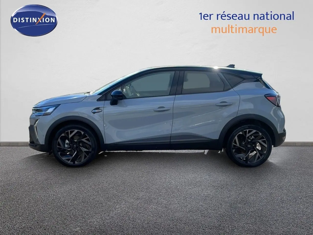 Profil côté gauche du Renault Captur E-Tech hybride 2025 gris rafale métal avec toit noir et jantes noires biton.