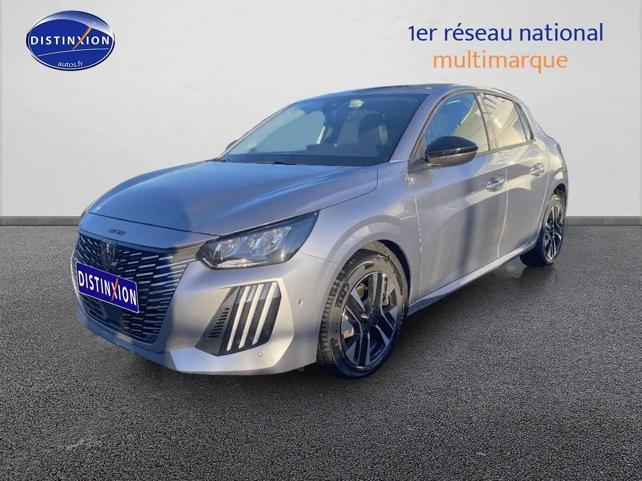 Vue 3/4 avant droit d'une Peugeot 208 gris artense avec jantes alu et phares LED allumés.