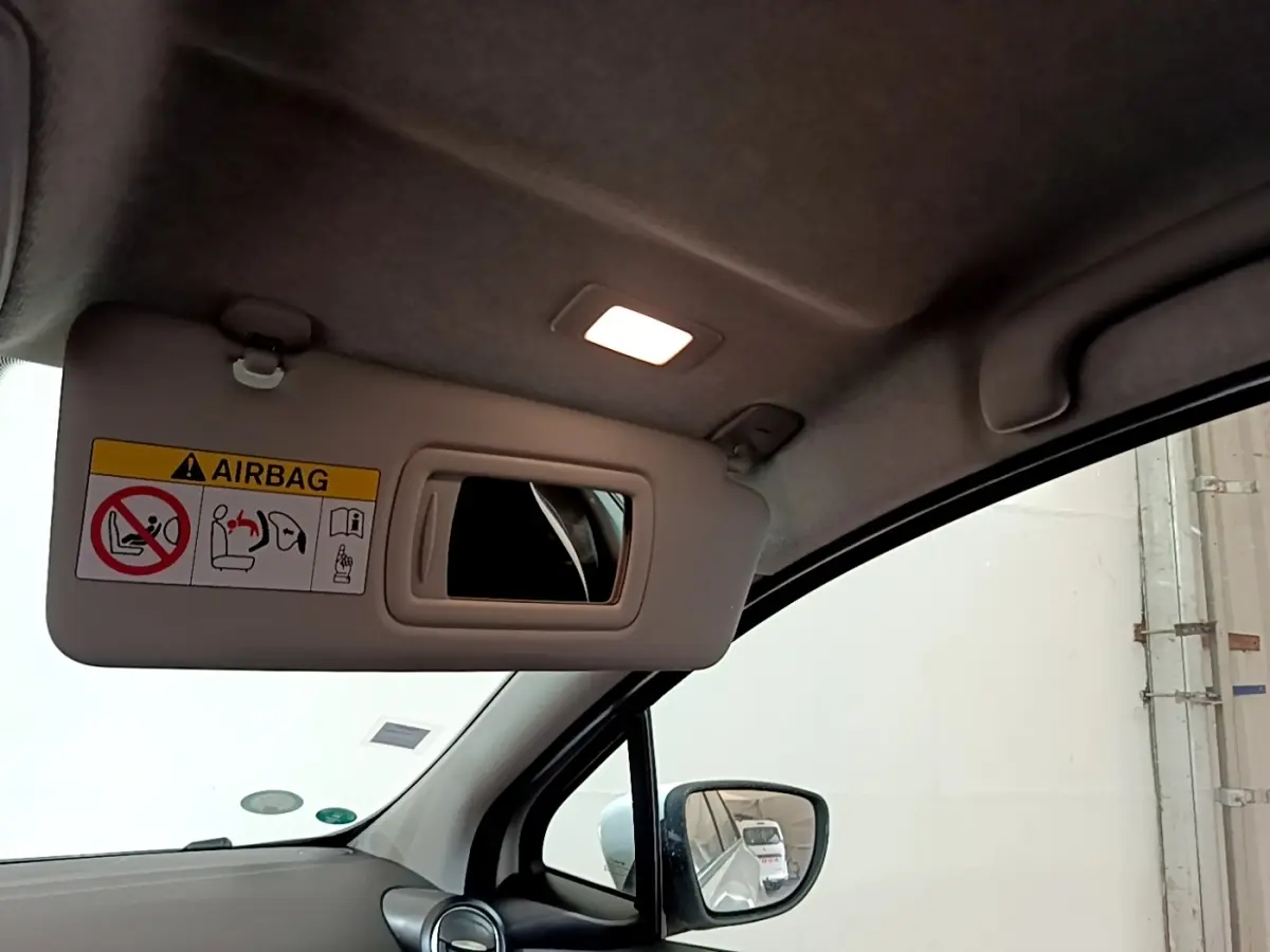 Vue intérieure du pare-soleil côté conducteur avec miroir et lumière allumée dans une Renault ZOE blanche de 2021.
