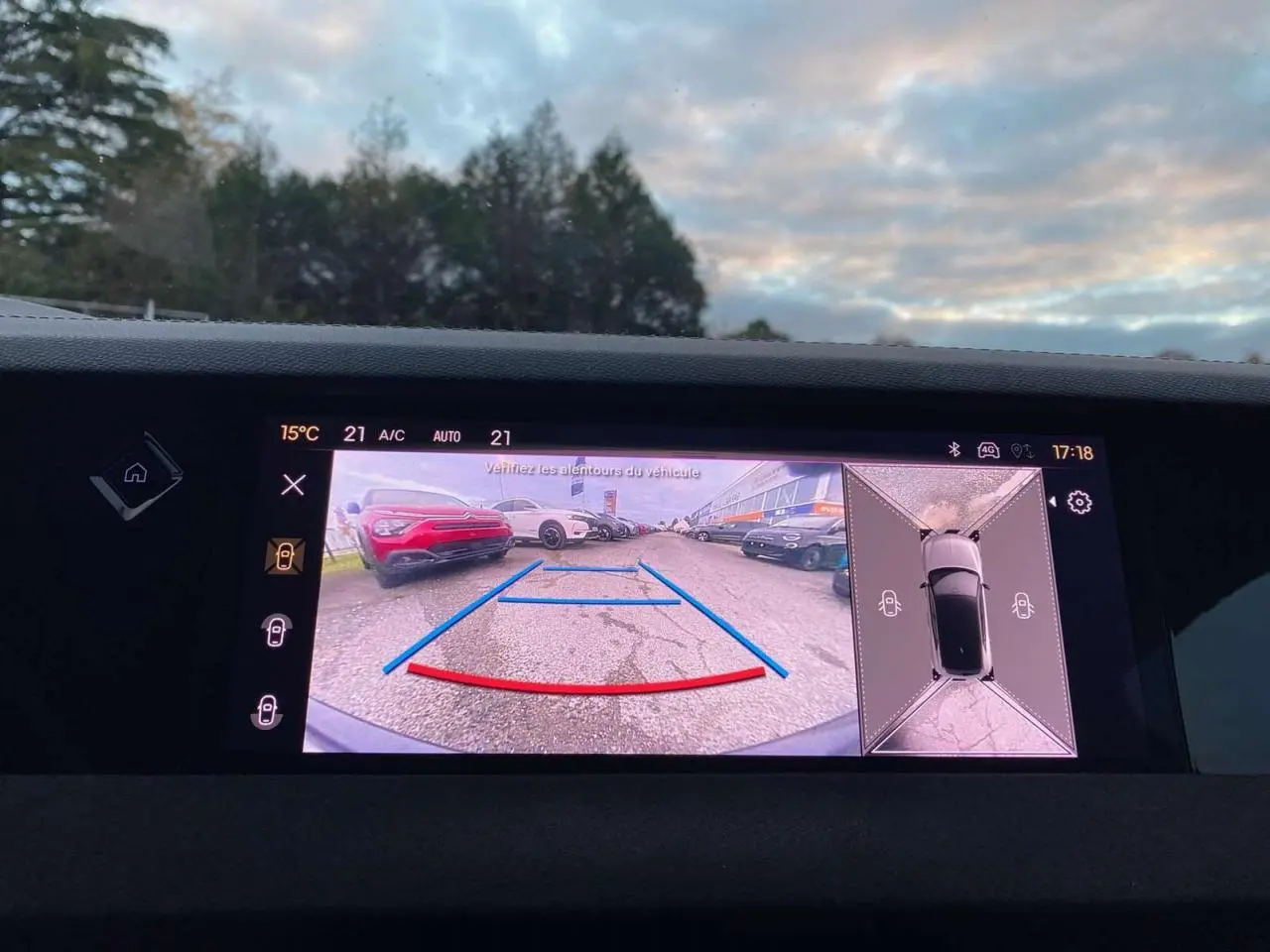 Écran multimédia du DS4 2022 montrant la caméra de recul avec vue arrière et top-down en stationnement.