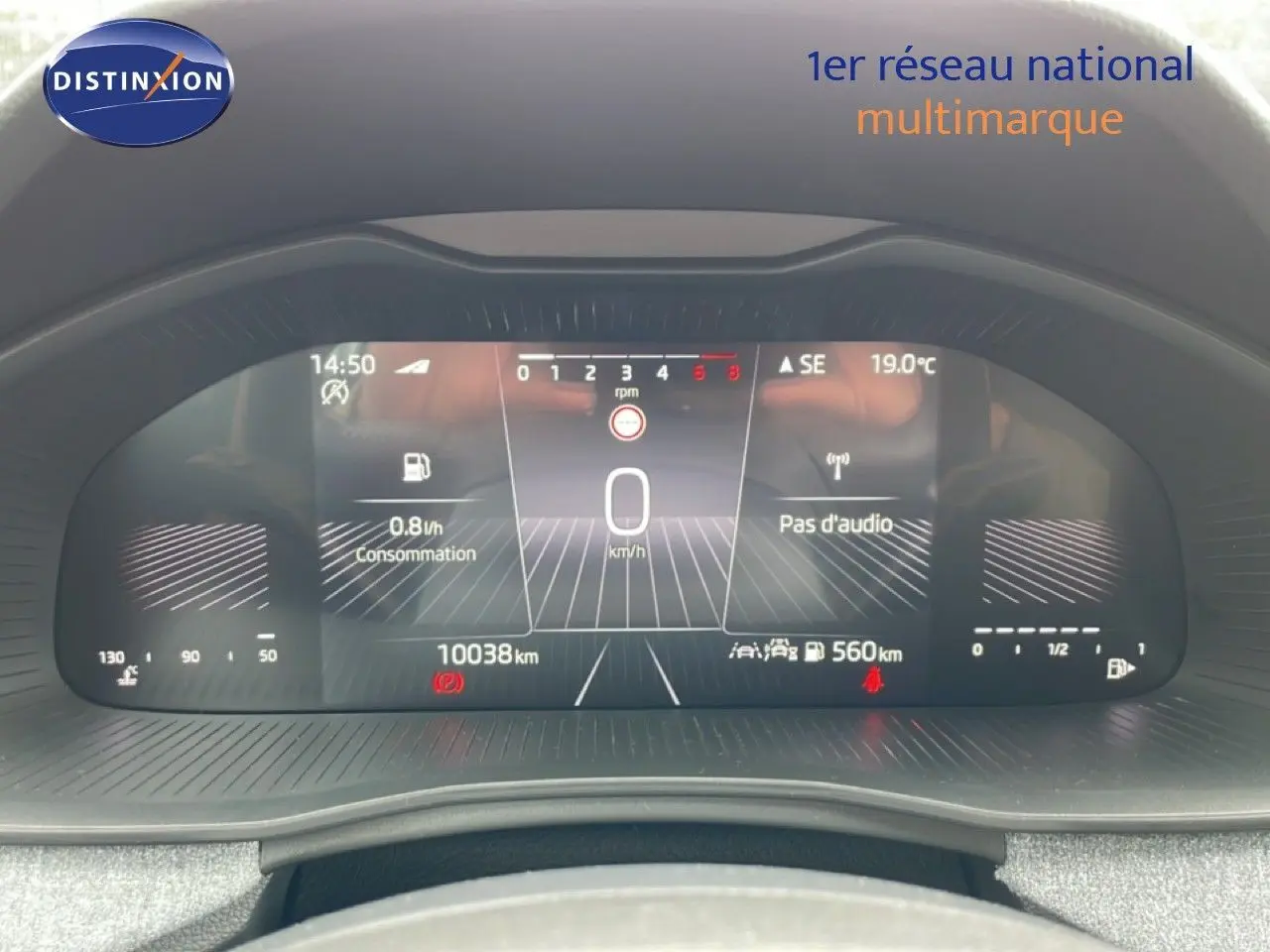 Vue rapprochée du tableau de bord numérique de la Skoda Scala noir magique, affichant la vitesse à 0 km/h et la consommation.