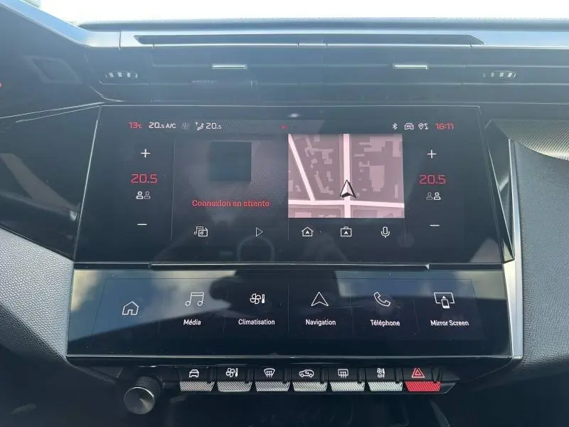 Vue rapprochée de l’écran tactile central multifonction de la Peugeot 308 gris Artense avec affichage navigation et climatisation.