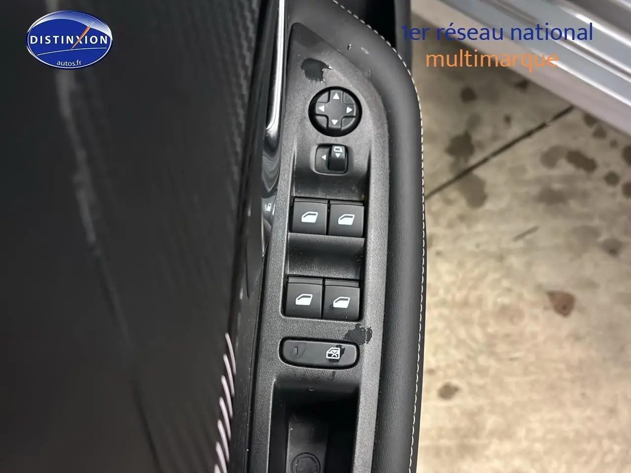 Détail des commandes des vitres électriques côté gauche intérieur d’une Peugeot 208 gris Artense.