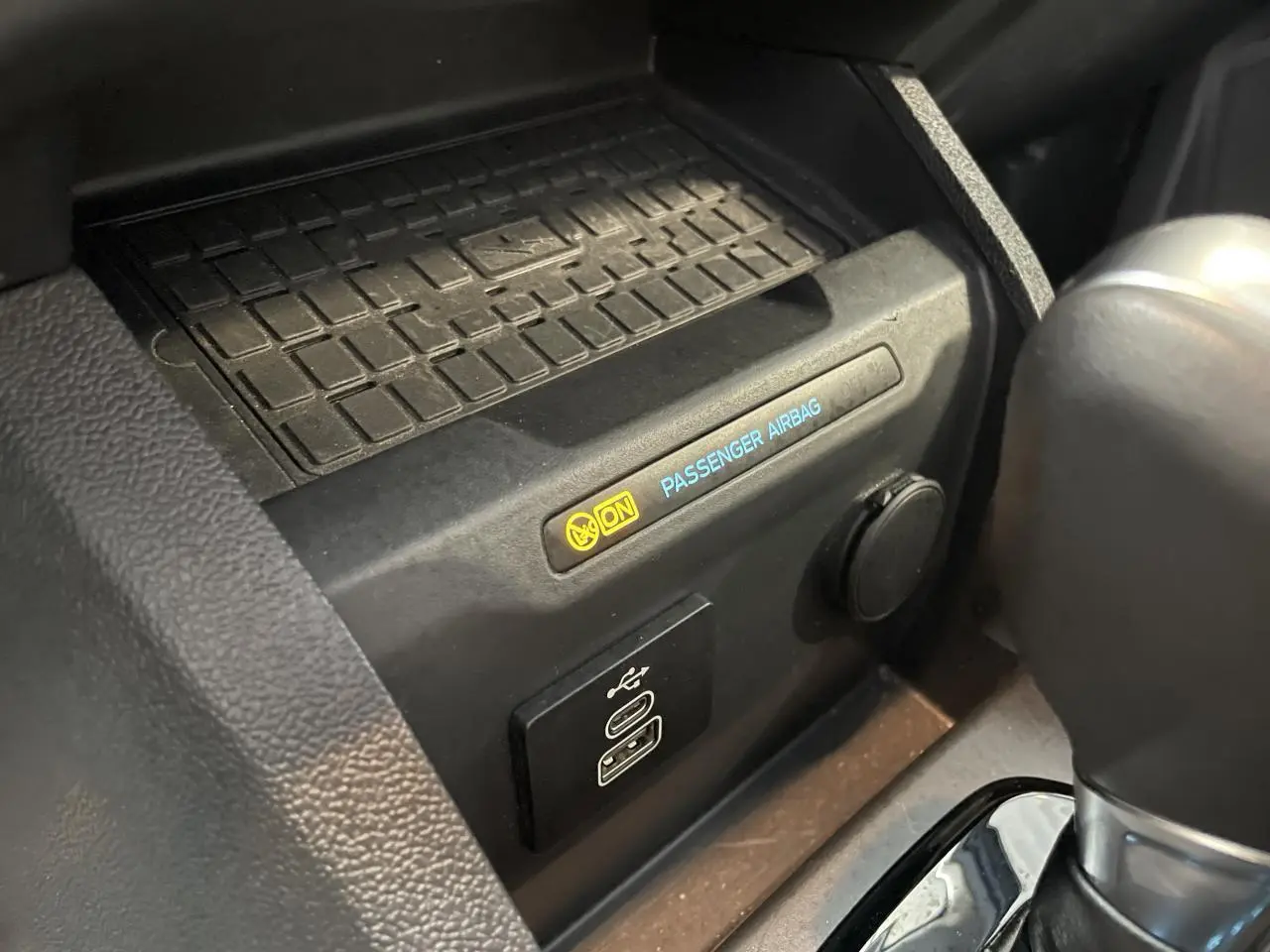Gros plan intérieur sur la console centrale du Ford Tourneo Courier 2024 montrant port USB-C et témoin airbag passager activé.