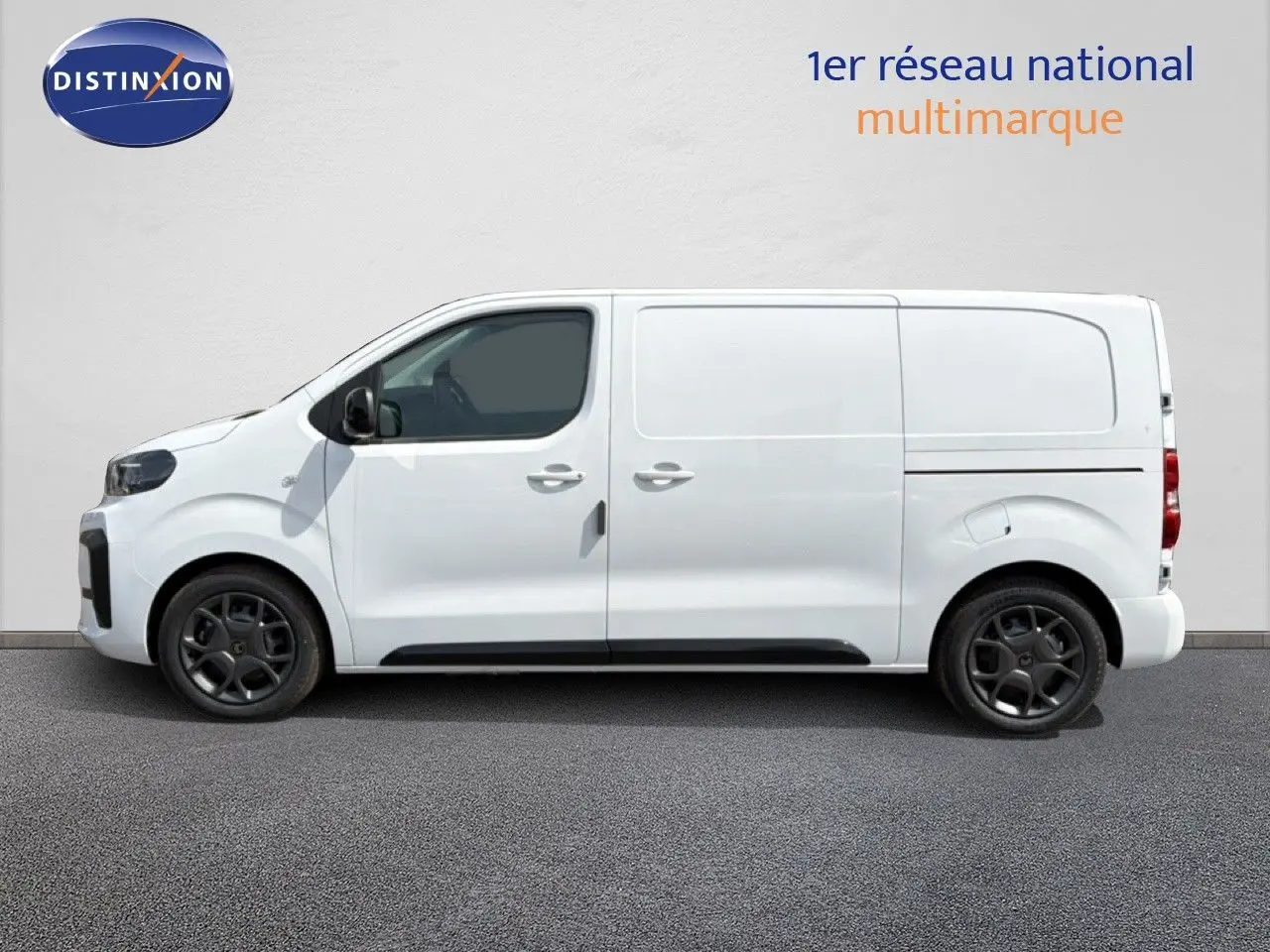Profil droit d’un Citroën Jumpy blanc Kaolin, fourgon utilitaire avec jantes noires et portes latérales coulissantes.