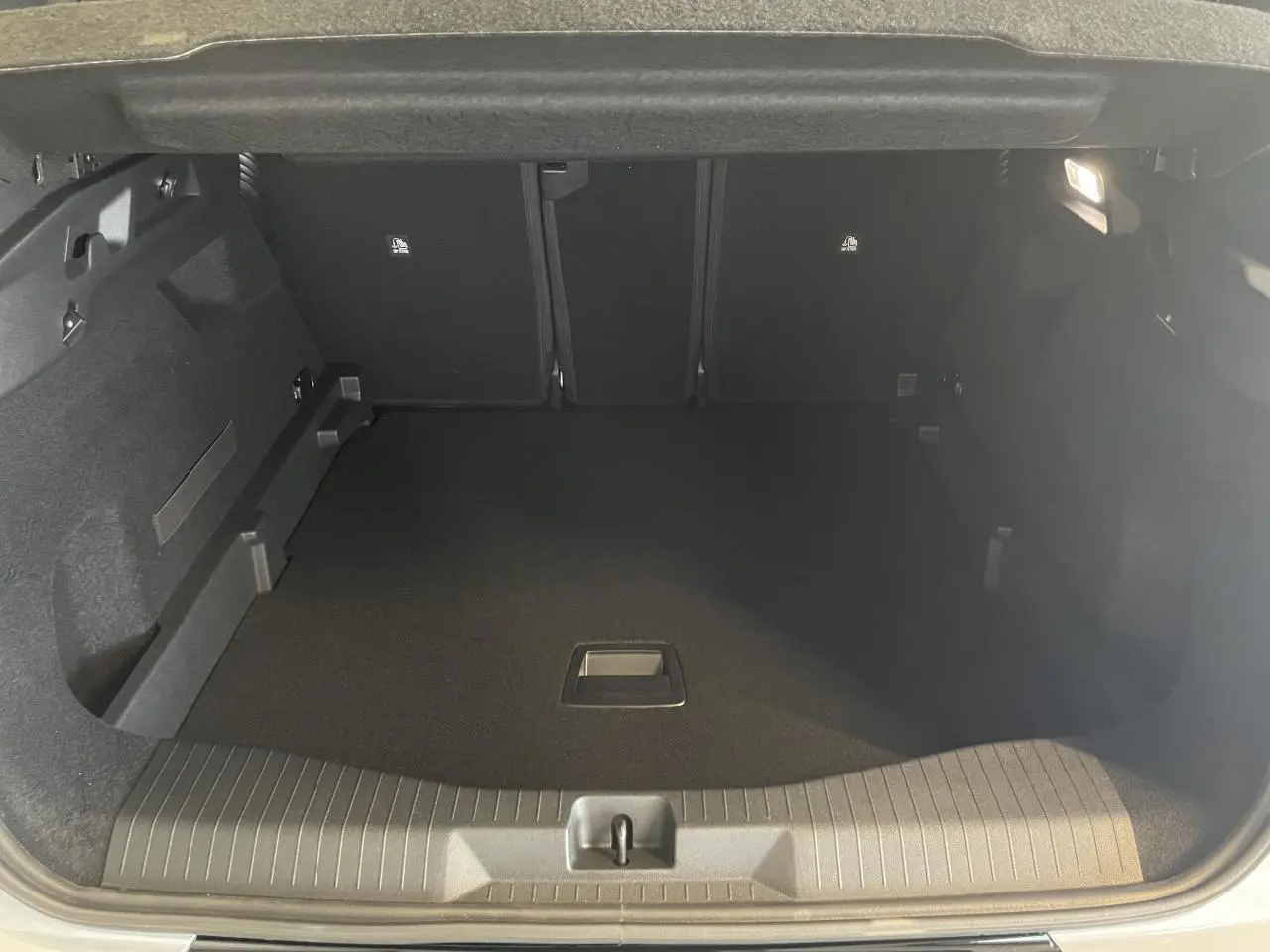 Coffre ouvert du Citroën C5 Aircross blanc Okenite, vue intérieure montrant un espace de chargement noir et épuré.