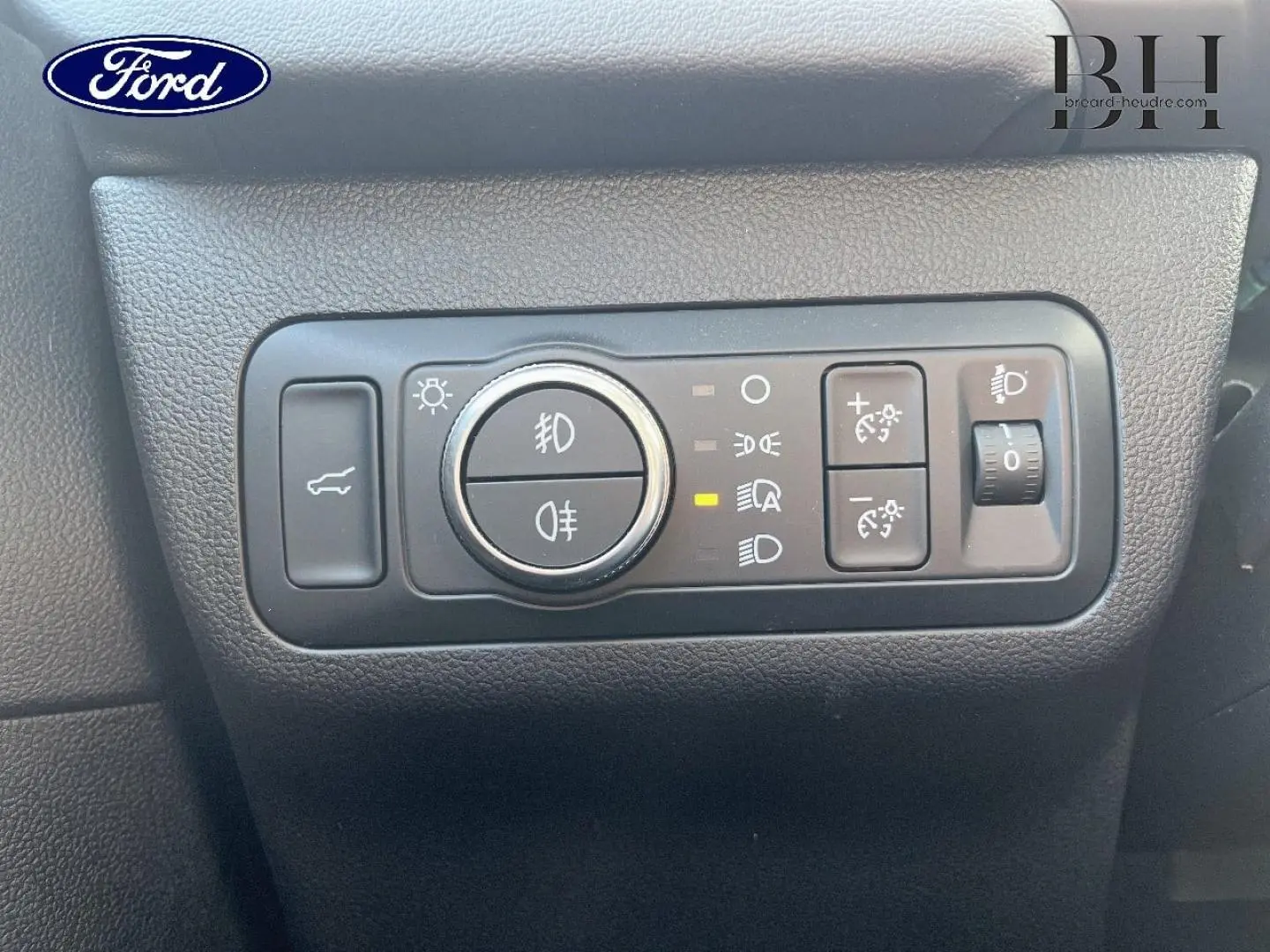 Panneau de commandes d’éclairage intérieur noir sur Ford Kuga 2023, avec bouton rotatif et réglages lumineux.