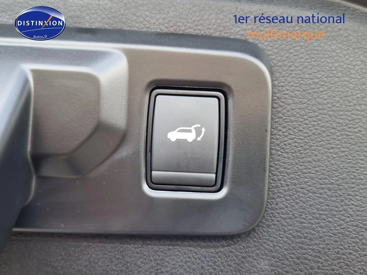 Bouton d'ouverture électrique du coffre sur panneau intérieur d'un Renault Espace VI gris schiste hybride 2025.
