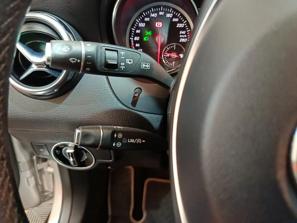 Vue rapprochée du tableau de bord gris d’une Mercedes GLA 200 d, avec commandes au volant et compteurs éclairés.