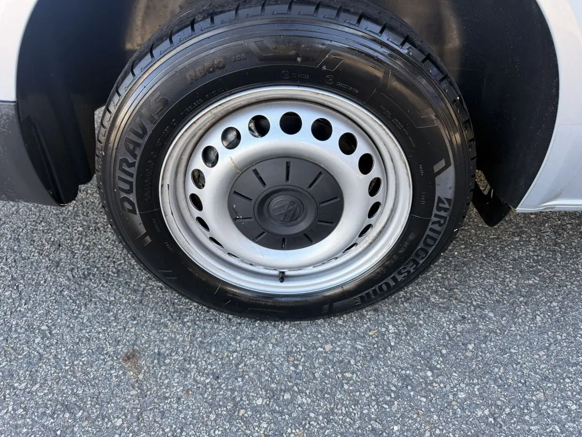 Gros plan sur la roue avant droite en jante acier gris clair du Volkswagen Transporter 2.0 TDi 110 L2H1 Business.