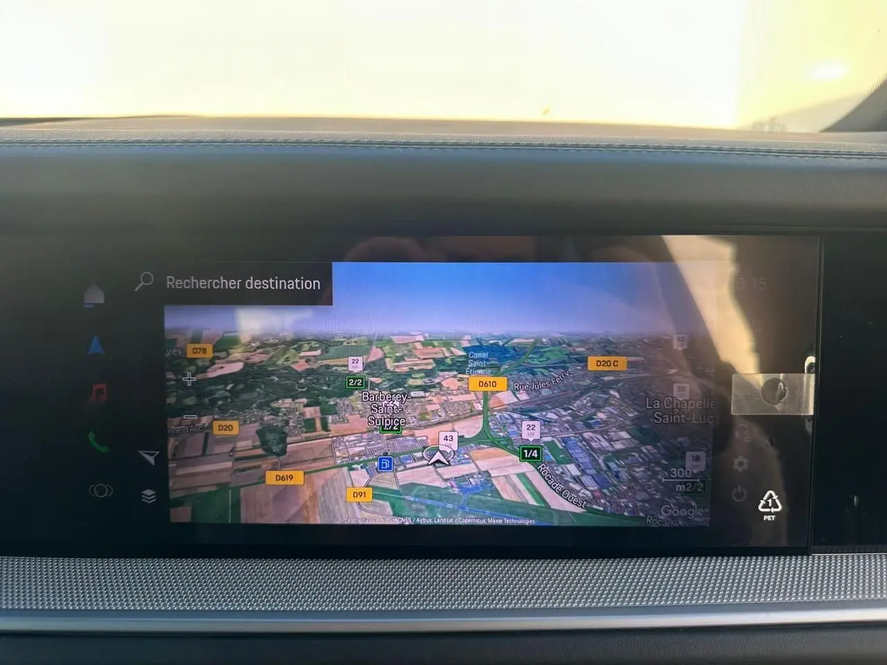 Écran tactile du système de navigation du Porsche Cayenne 2024, affichant une carte en vue satellite.