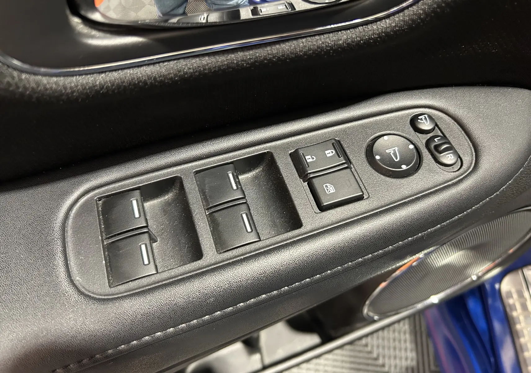 Détail des commandes de lève-vitres et rétroviseurs côté conducteur du Honda HR-V bleu 2020, intérieur noir.