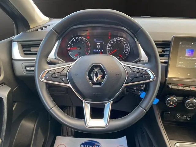 Vue centrée sur le volant noir du Renault Captur TCe 90 Équilibre 2023 avec tableau de bord et écran tactile visible.