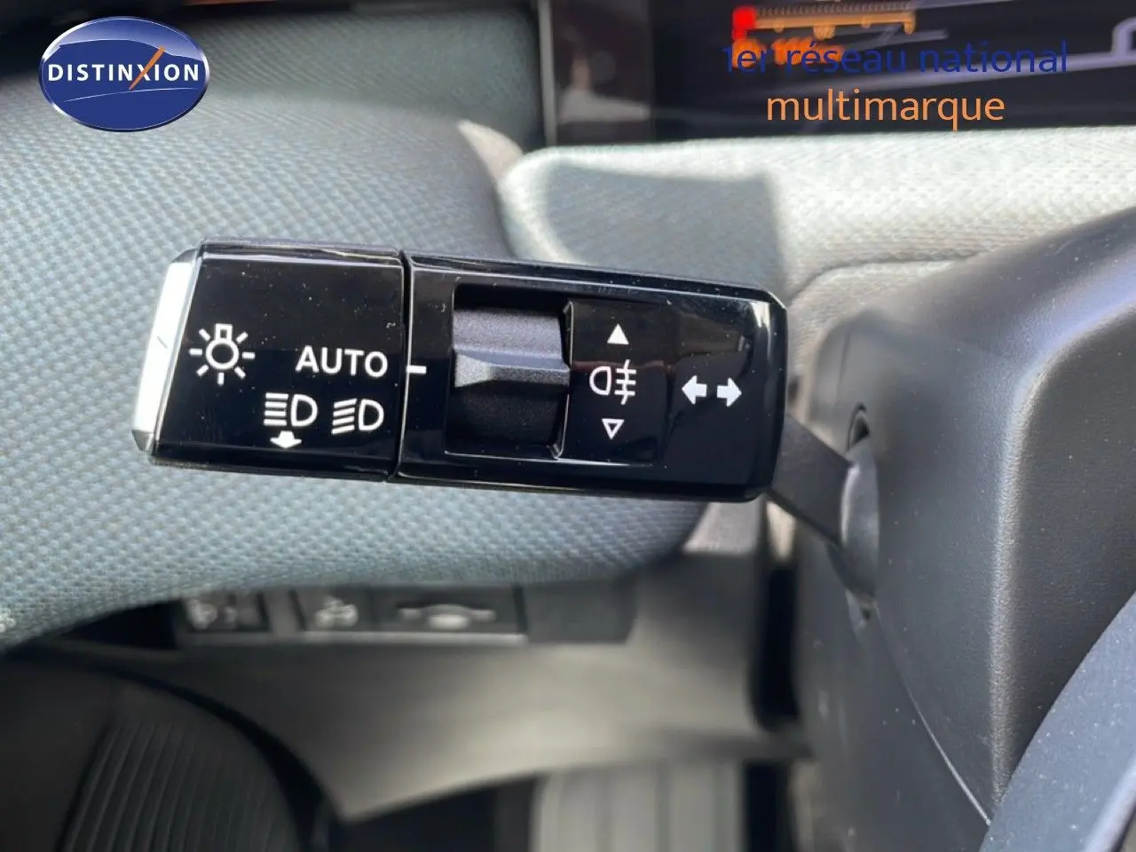 Gros plan sur la commande des feux et clignotants du Citroën C5 Aircross Hybrid rouge rubis, intérieur tissu gris.
