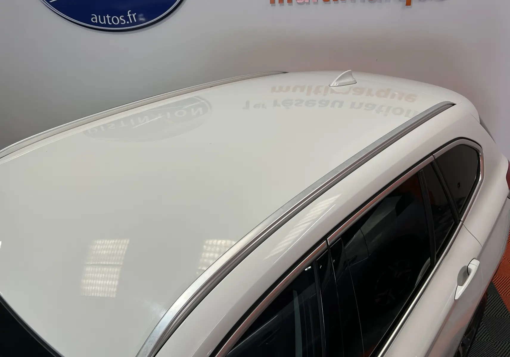 Vue en plongée du toit blanc et des vitres teintées côté droit du BMW X1 sDrive18iA 2018 avec antenne requin.